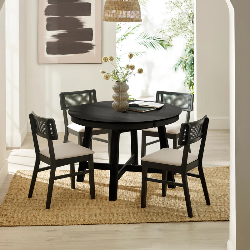ROUND BLACK DINING TABLE ON A WHITE BACKGROUND 