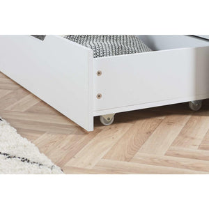 White bed frame with drawer on wheels on a wooden floor