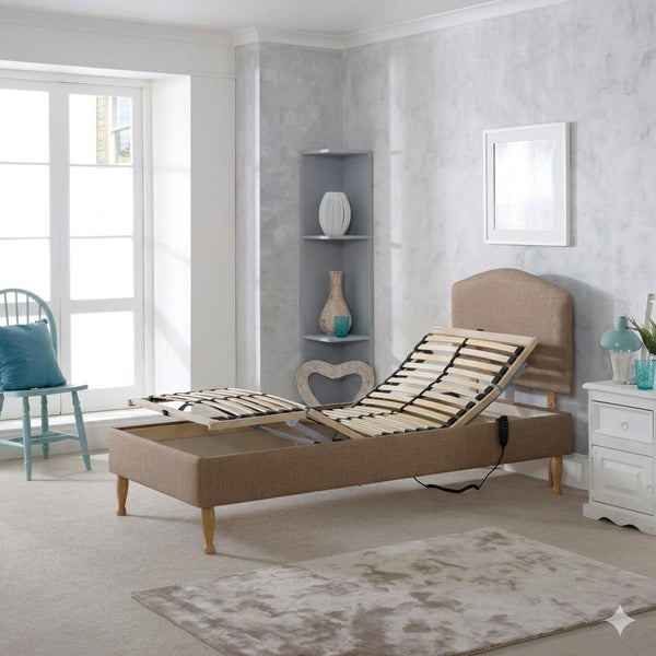 Beige adjustable bed in a room with a window, shelves, and decorative items.