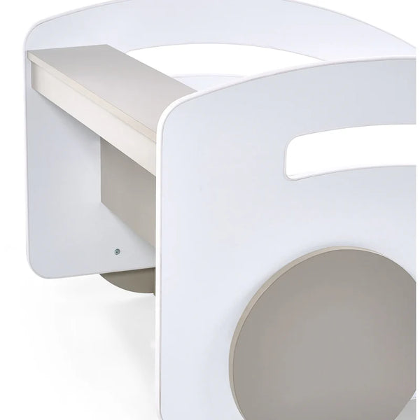 White children's bed with a small desk attached to one side on a white background