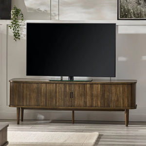 Large flat-screen TV on a wooden stand in a living room setting.