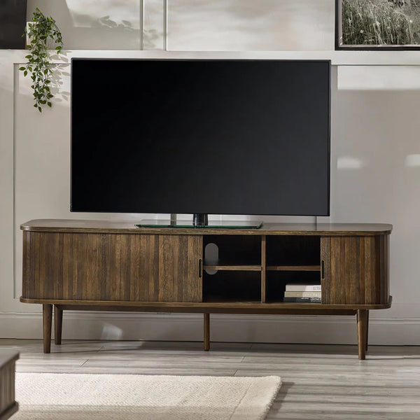 Wooden TV stand with a large flat-screen TV in a living room setting.