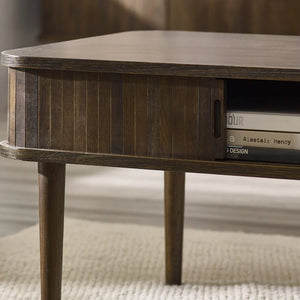 Wooden side table with books on a neutral background
