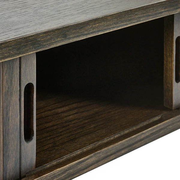 Close-up of a wooden TV stand with a rustic finish.