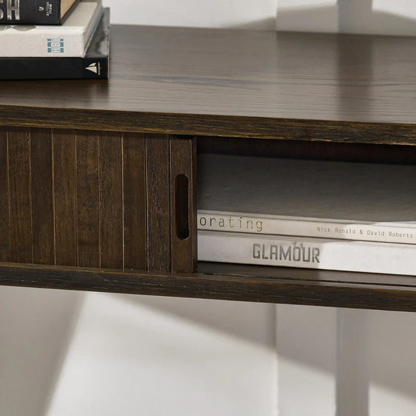 Wooden shelf with books and a magazine titled 'Glamour' on a white background