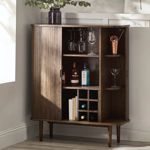 Wooden bar cabinet with drinks and glasses in a home setting