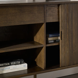 Wooden cabinet with open door revealing books inside, on a dark background