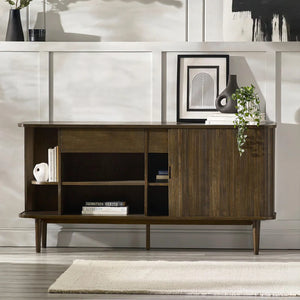 Wooden sideboard in a living room setting with decor items.