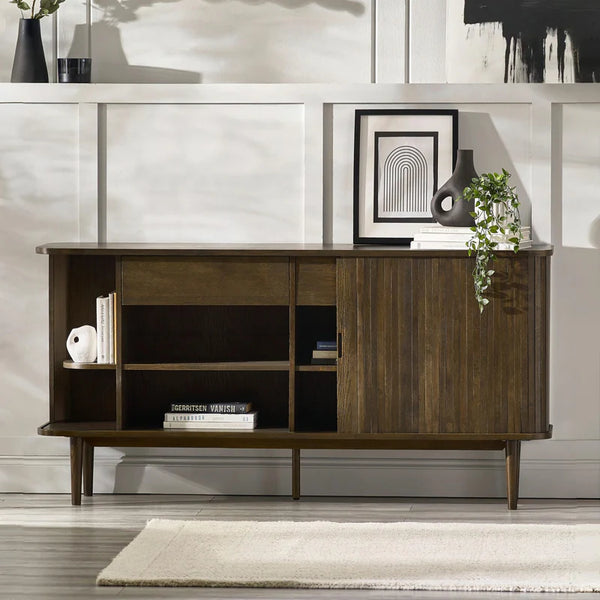 Wooden sideboard in a living room setting with decor items.