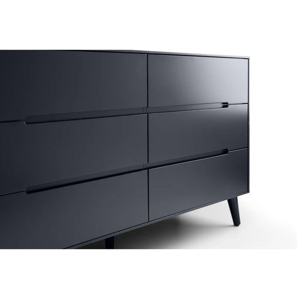 Black dresser with four drawers on a white background