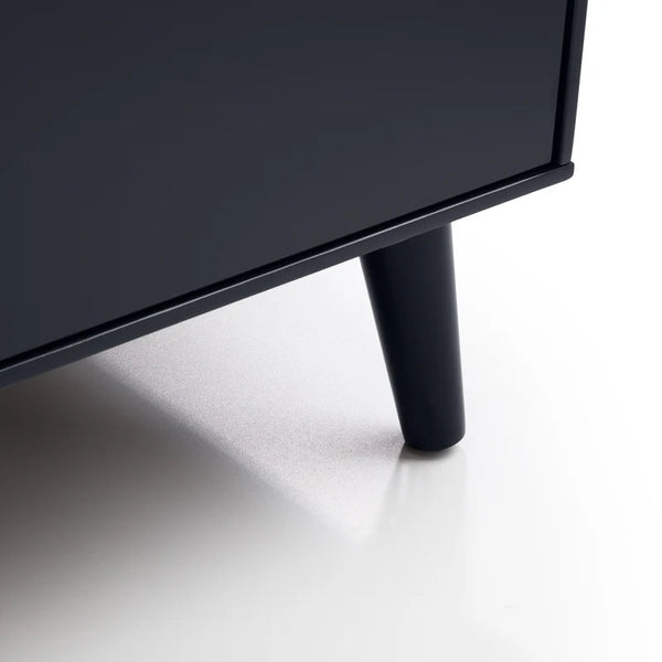 Close-up of a black TV stand leg on a white background