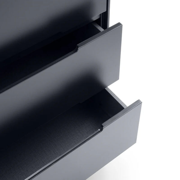 Close-up of a metallic drawer with a grid pattern on a white background