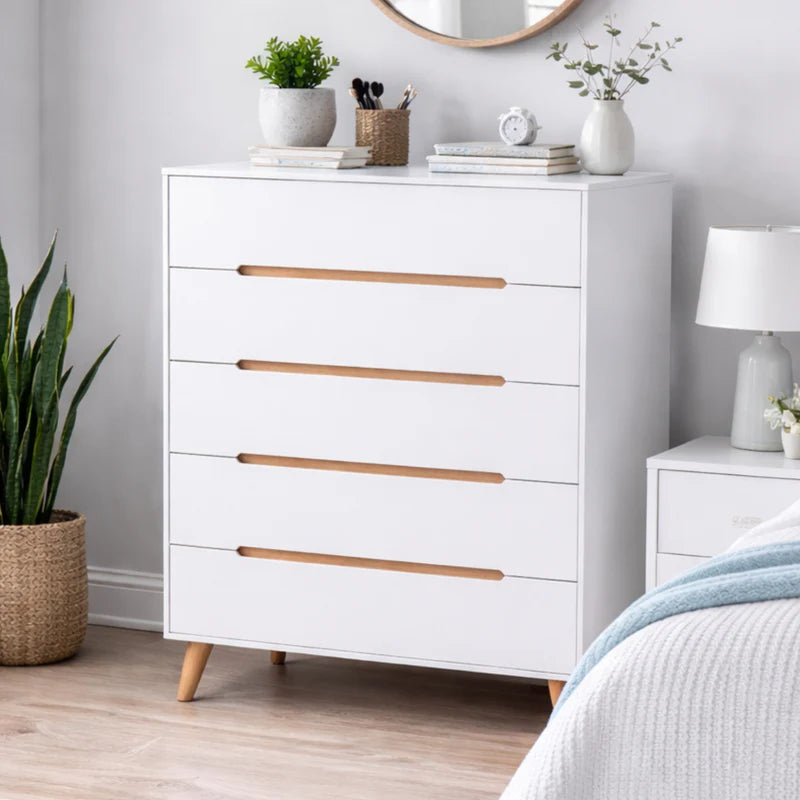White dresser with wooden drawers and legs on a white background