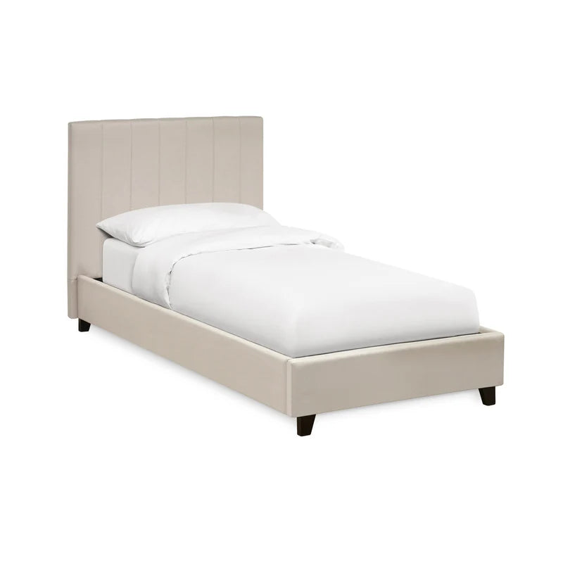 Beige upholstered bed with white bedding on a white background