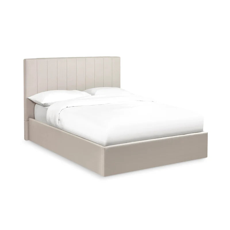 Beige upholstered bed with white bedding on a white background