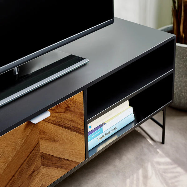 Modern TV stand with a television and books on a neutral background