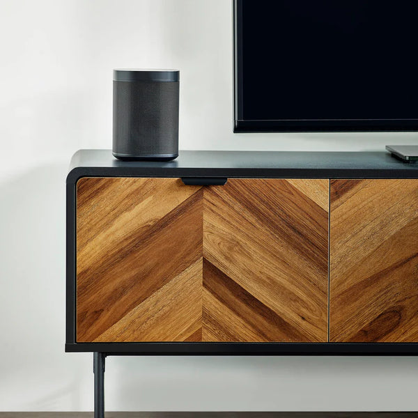 Wooden entertainment console with a television and speaker on top