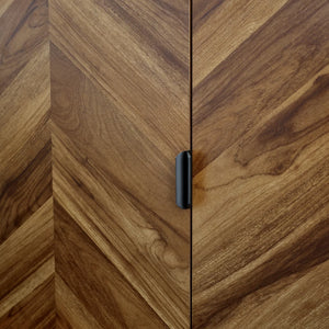 Close-up of a wooden cabinet with a black handle