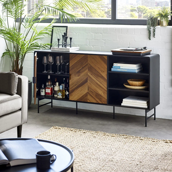 Modern living room with a black and wood sideboard, gray sofa, and coffee table.