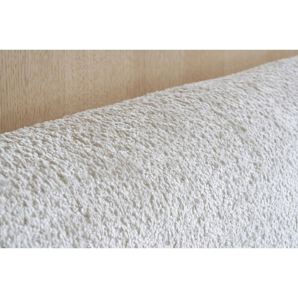 Close-up of textured white fabric on a beige background