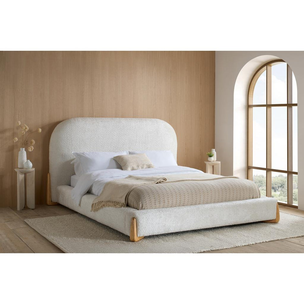 White bed frame with mattress on a white background