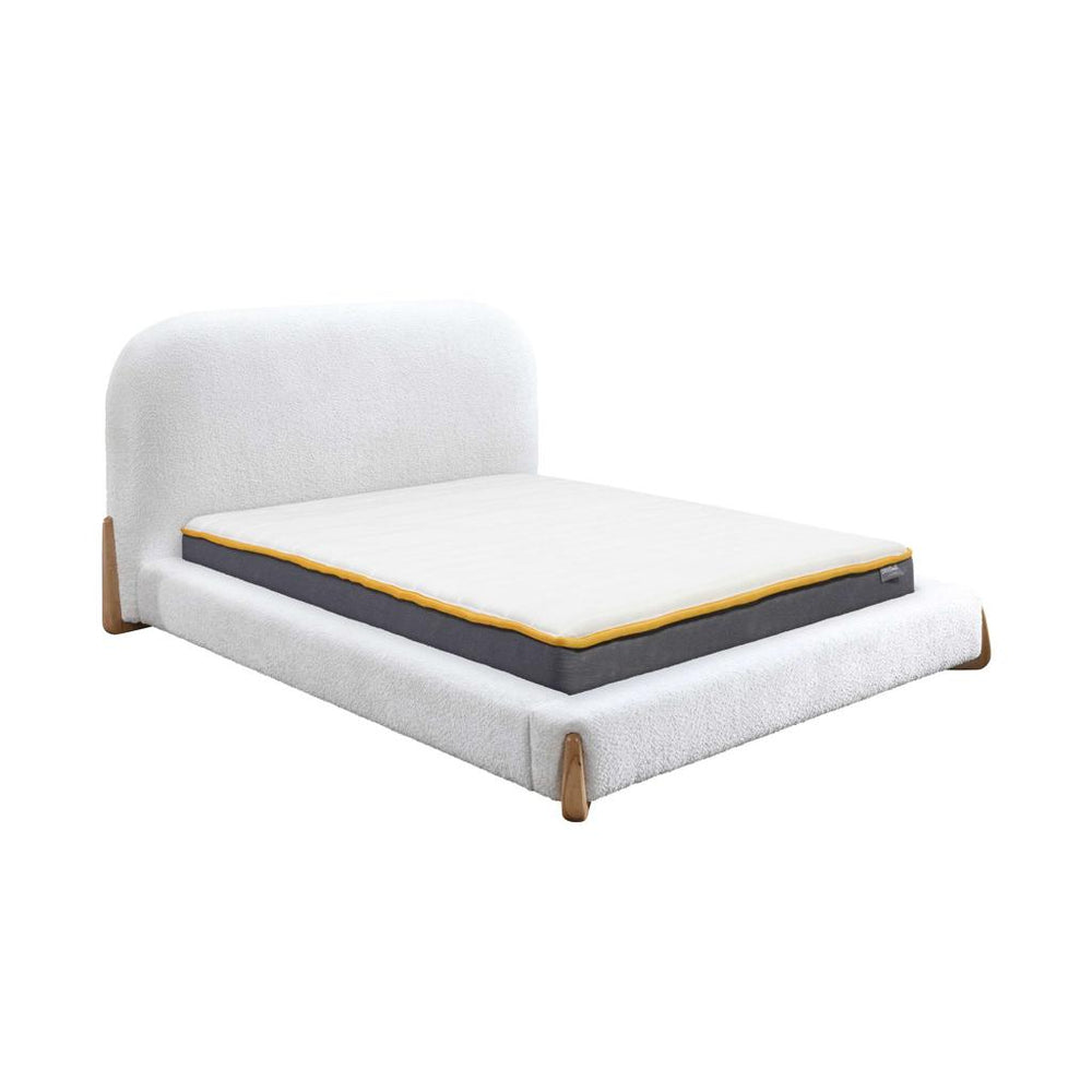 White bed frame with mattress on a white background