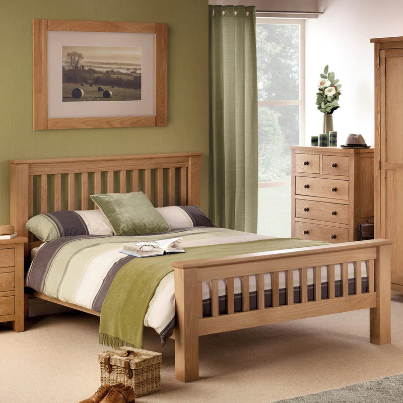 Wooden bed with light blue bedding on a white background