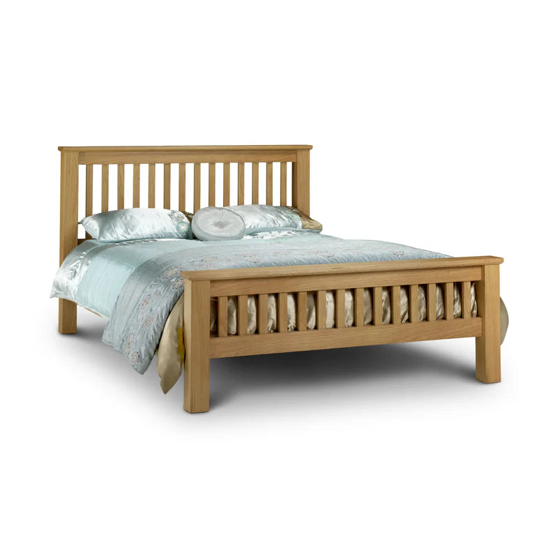Wooden bed with light blue bedding on a white background