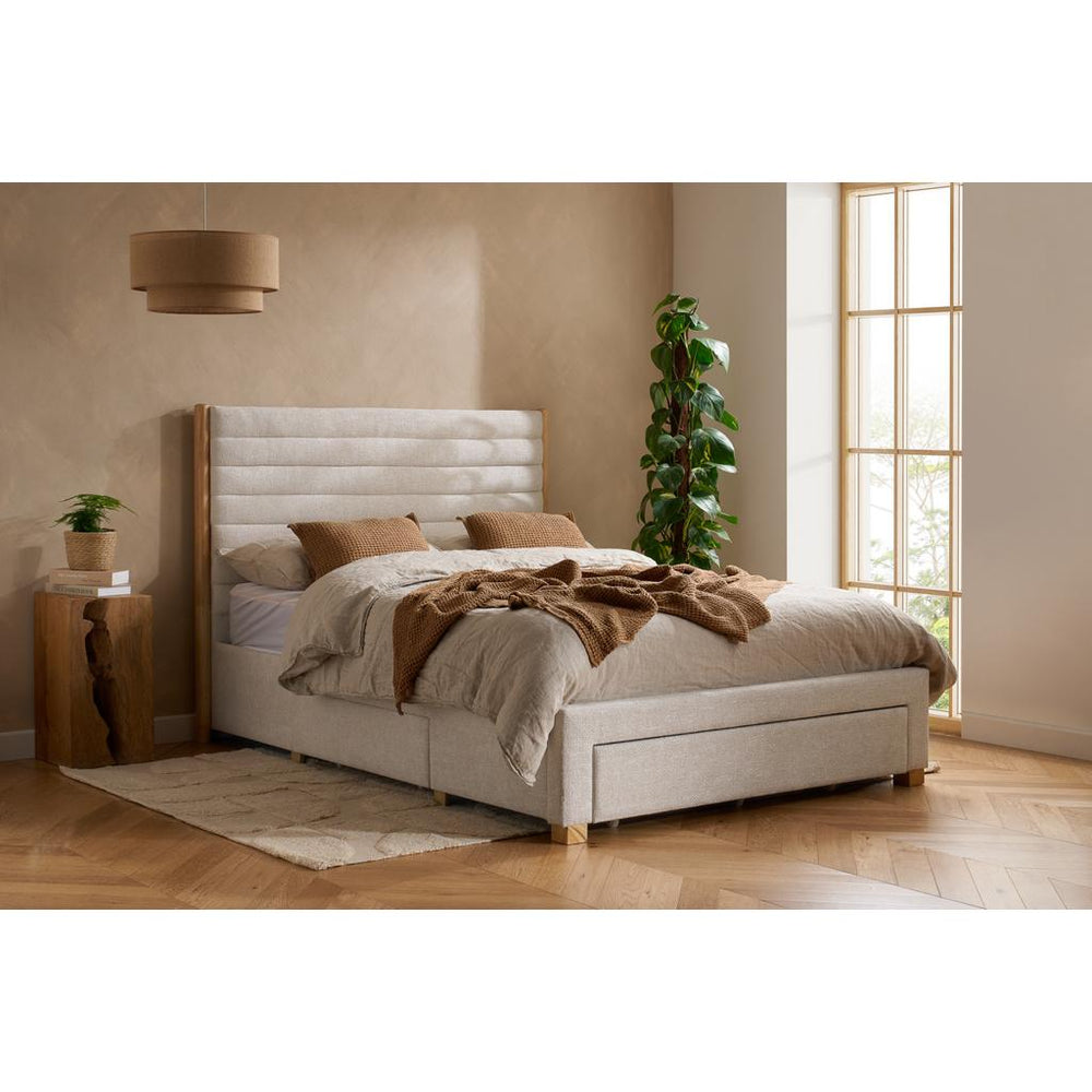 Beige upholstered bed with mattress on a white background