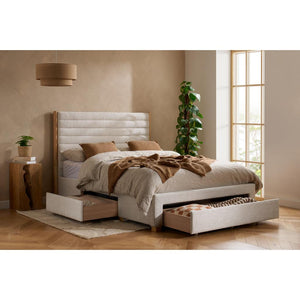 White upholstered bed with storage drawers in a bedroom setting.