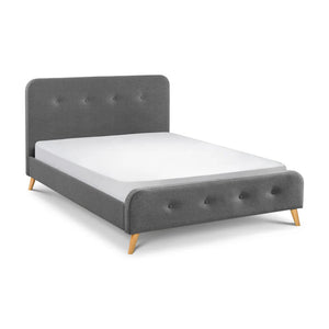 Gray upholstered bed with a white mattress on a white background
