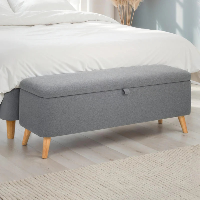 Gray storage bench with wooden legs on a white background