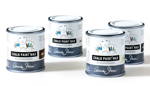 Four cans of Annie Sloan Chalk Paint Wax on a white background