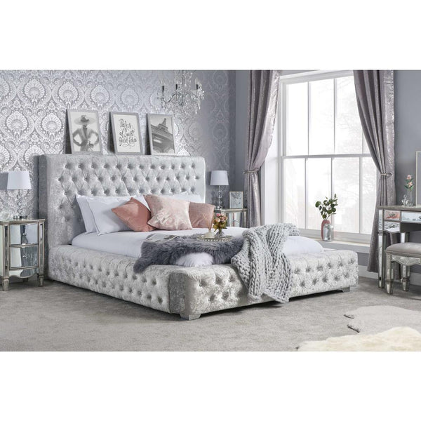 Decorative bedroom with a tufted bed, side tables, and wall art.