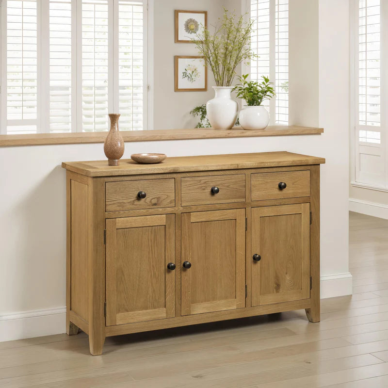 Wooden sideboard with three doors and three drawers on a white background