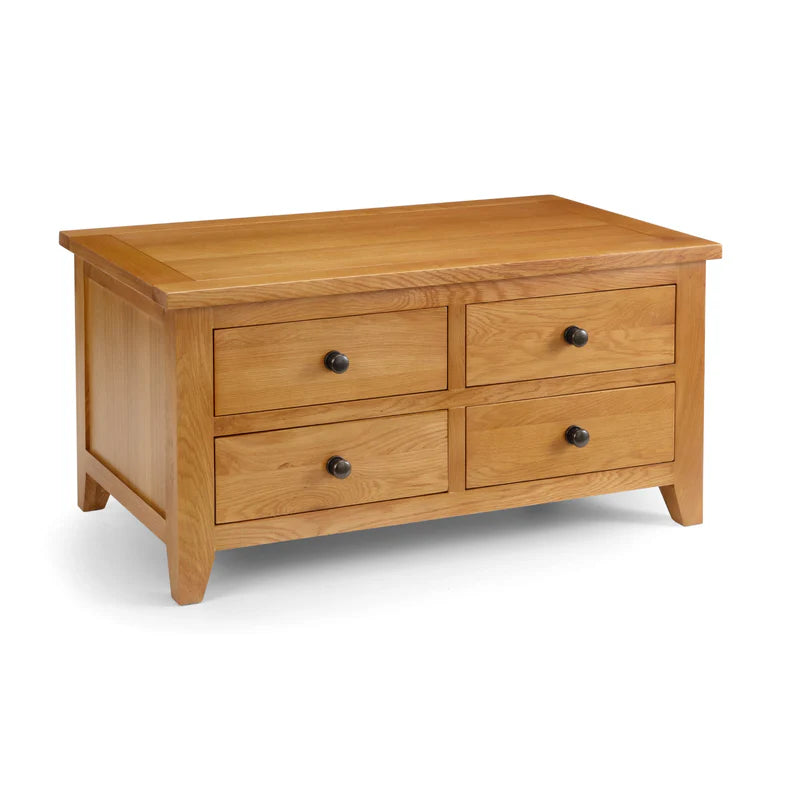 Wooden coffee table with four drawers on a white background
