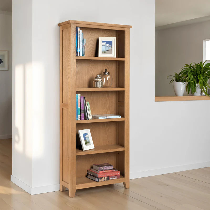 Wooden bookshelf with books and decorative items on a white background