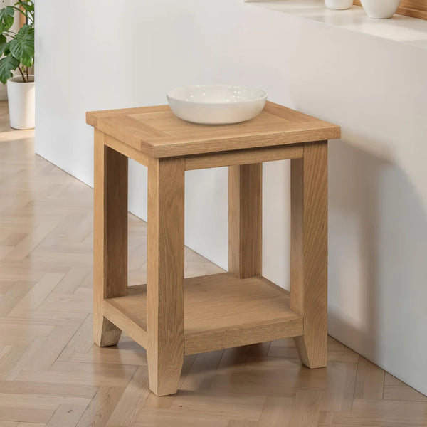 Wooden side table with a bowl on top in a room setting
