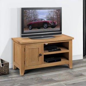 Wooden TV stand with a television displaying an image of a red car on a white wall.