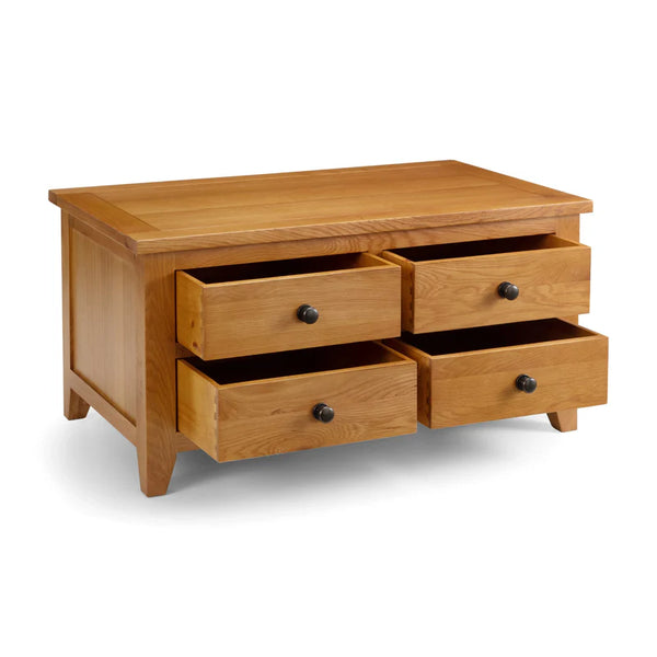 Wooden coffee table with four drawers on a white background