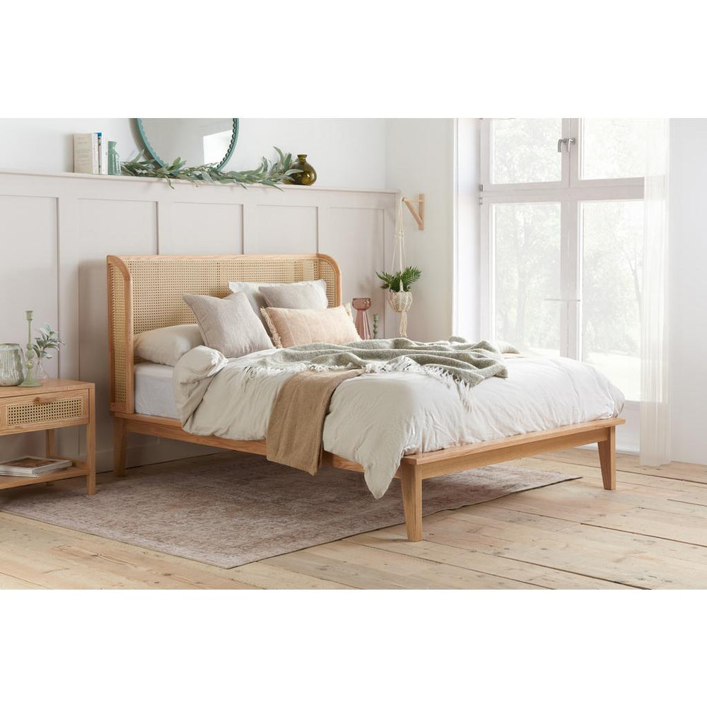 Wooden bed frame with mattress on a white background