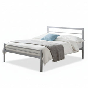 Modern bedroom with a metal bed, blue walls, and decorative elements.