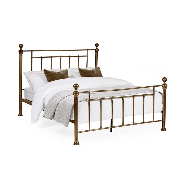 Bronze bed frame with white bedding on a white background