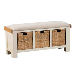 White storage bench with three wicker basket compartments on a white background