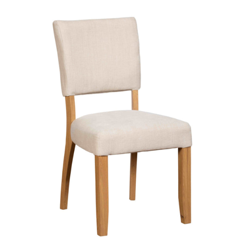 Beige upholstered chair with wooden legs on a white background