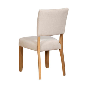 Beige upholstered chair with wooden legs on a white background