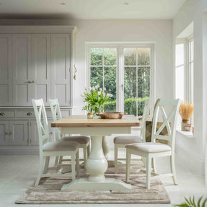Dining room with wooden table and chairs in a bright, well-lit room.