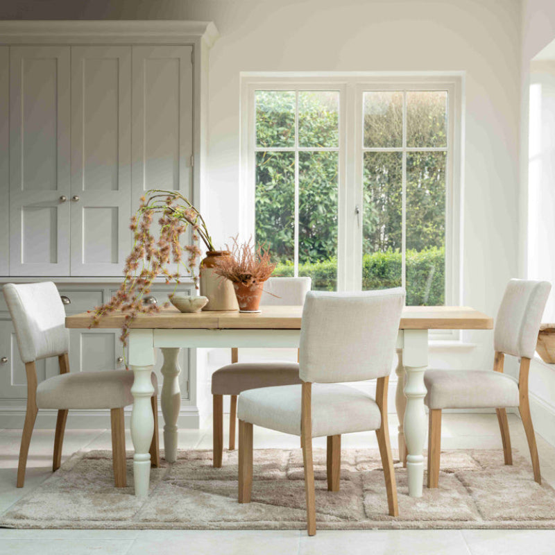 Wooden dining table with white base on a white background