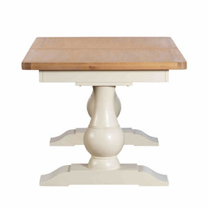 Wooden table with a white pedestal base on a white background