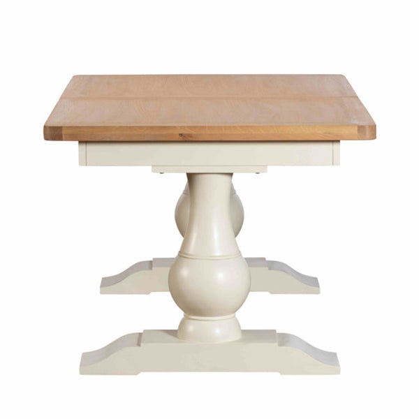 Wooden table with a white pedestal base on a white background